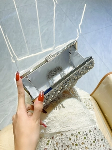 Elegant silver evening clutch bag with sparkling diamond fringe and metal chain strap