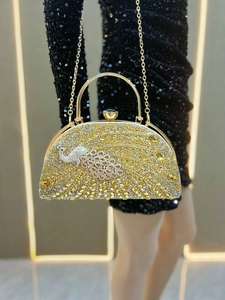 Detailed view of the luxury peacock rhinestone clutch bag with golden metal handle