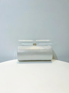 Close-up of sparkling silver sequin evening bag with elegant crystal square clasp