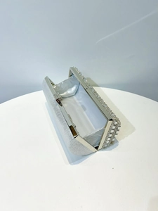 Detail of silver rhinestone evening clutch with sparkling finish and satin lining