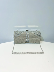 Detail of silver evening clutch featuring sparkling rhinestones and elegant fringe tassels