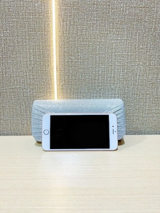 Silver glitter evening clutch size comparison with a white smartphone on wooden surface
