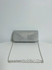 Detail of silver pleated evening clutch with glitter texture and metallic chain strap