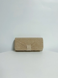 Close-up of golden sequin evening clutch bag with radial pleats and metallic shine