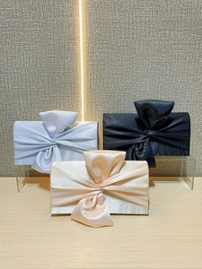 Elegant evening clutch bags with bow knots in silver, black, and champagne satin colors