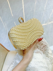 Elegant white pearl evening clutch with sparkling diamond buckle and wave texture design
