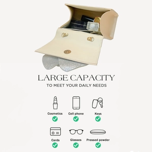 Detail showing large capacity of evening clutch bag holding cosmetics and phone