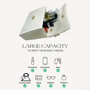 Internal view of cream leather crossbody bag showing capacity for phone and makeup