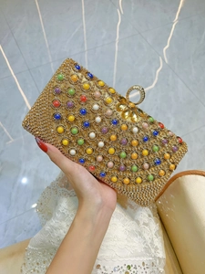 Golden rhinestone evening clutch bag with multicolored gemstones and crystal ring closure