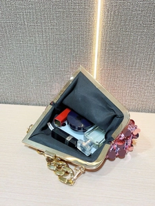 Pink sequin evening bag showing interior capacity for lipstick, cushion and perfume