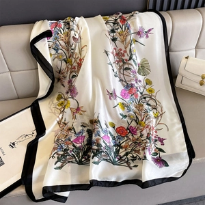 Floral silk scarf with black borders and colorful botanical prints on white satin fabric