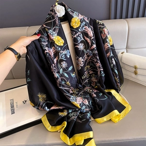 Detail of floral silk scarf with elegant yellow border and vintage French print