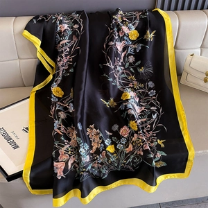 Detailed view of floral silk scarf featuring vibrant tulips on high-quality black fabric