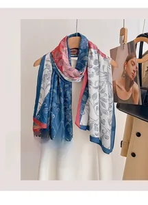 Detail of lightweight floral beach scarf with navy and pink botanical prints hanging