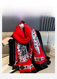 Close-up of red floral silk scarf featuring satin texture and geometric patterns