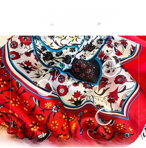 Detail of red floral satin scarf showing high-quality fabric texture and breathable print