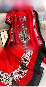 Detail of red floral silk shawl showing precise stitching and active charcoal dyeing finish