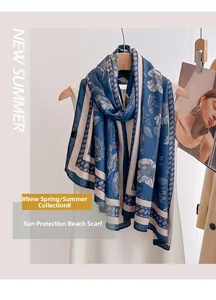 Detailed view of lightweight navy floral shawl draped on a hanger over a dress