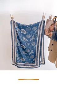 Detail showing botanical print and texture on a navy blue summer beach shawl scarf