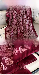 Detail showing high-quality hemmed edges on a burgundy paisley silk chiffon scarf shawl