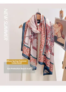 Detail of leopard print silk scarf on a wooden hanger with deep blue border trim