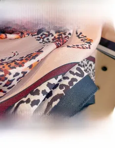 Detail shot of leopard and herringbone pattern scarf with soft cotton-linen texture