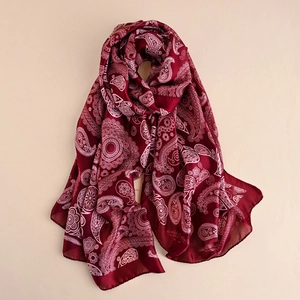 Detailed view of dark wine red paisley silk shawl with fine edge stitching and smooth texture