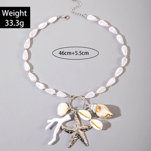 Detail of bohemian seashell necklace with starfish charms and white teardrop beads
