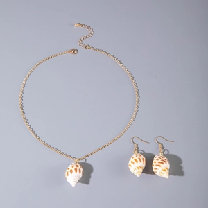 Detail view of natural spiral shell pendant necklace and earrings set with gold chain