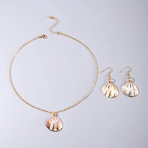 Detailed view of natural shell pendant necklace and earrings with gold metal chain