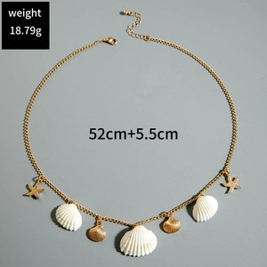 Detail of shell and starfish charms on a gold chain necklace with measurement labels