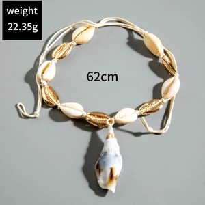 Handmade bohemian shell necklace featuring natural white shells and gold metal accents