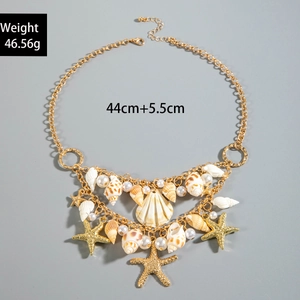 Detail view of Bohemian seashell and starfish pendant necklace with faux pearls and gold chain