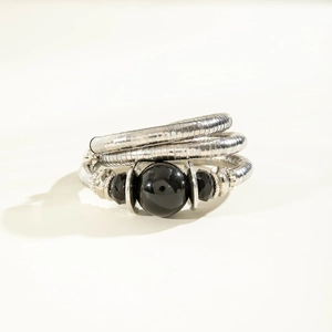 Detail of snake chain bracelet with large black bead and faceted glass accents