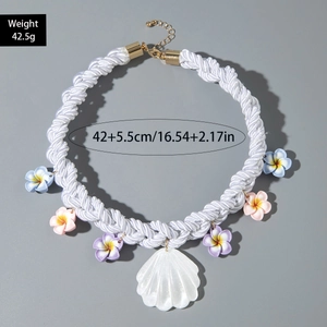 Detail of bohemian shell necklace with colorful floral charms and woven rope chain