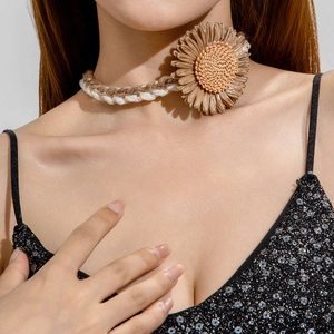 Detailed view of bohemian woven choker featuring a large handmade raffia flower pendant