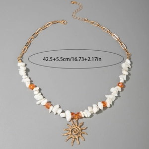 Detail view of Bohemian shell necklace showing the sun pendant and 42.5cm size dimension