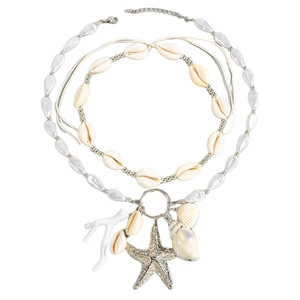Bohemian multilayer shell and starfish pendant necklace with faux pearls on white background