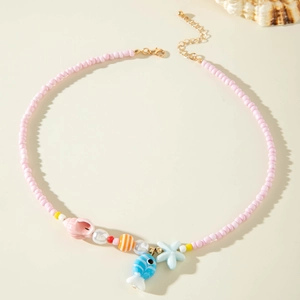 Detail view of beach theme beaded necklace with pink starfish and seashell charms