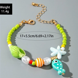Detail of colorful ocean-themed beaded bracelet with starfish and seashell charms