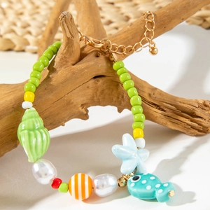 Close-up of ocean-themed beaded necklace with starfish, shell, and fish pendants