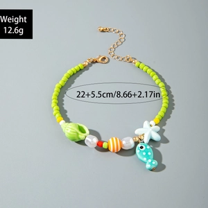 Detail of beaded beach anklet with starfish and seashell charms in ocean style