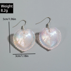 Macro view of iridescent heart earrings showing pearlescent texture and size dimensions