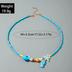 Detail of blue beaded ocean necklace with starfish, seashell, and fish pendants