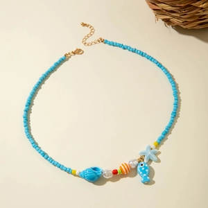 Close-up of ocean-style beaded necklace with starfish, seashell and fish pendants