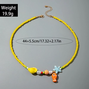 Detailed view of yellow beaded ocean necklace featuring starfish and fish charms