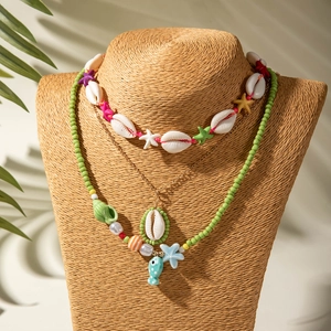Detail of bohemian ocean necklaces with starfish, seashells, and colorful beads