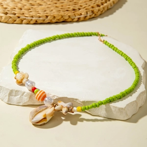 Macro detail of summer beach beaded necklace with starfish charms and shells