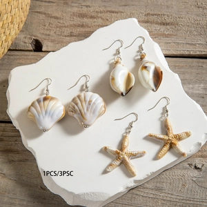 Detail showing a beach-style earring set with seashell, conch, and starfish charms