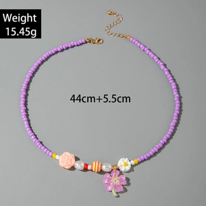 Detail of beaded necklace with sea shells, flowers, pearls and lobster clasp closure